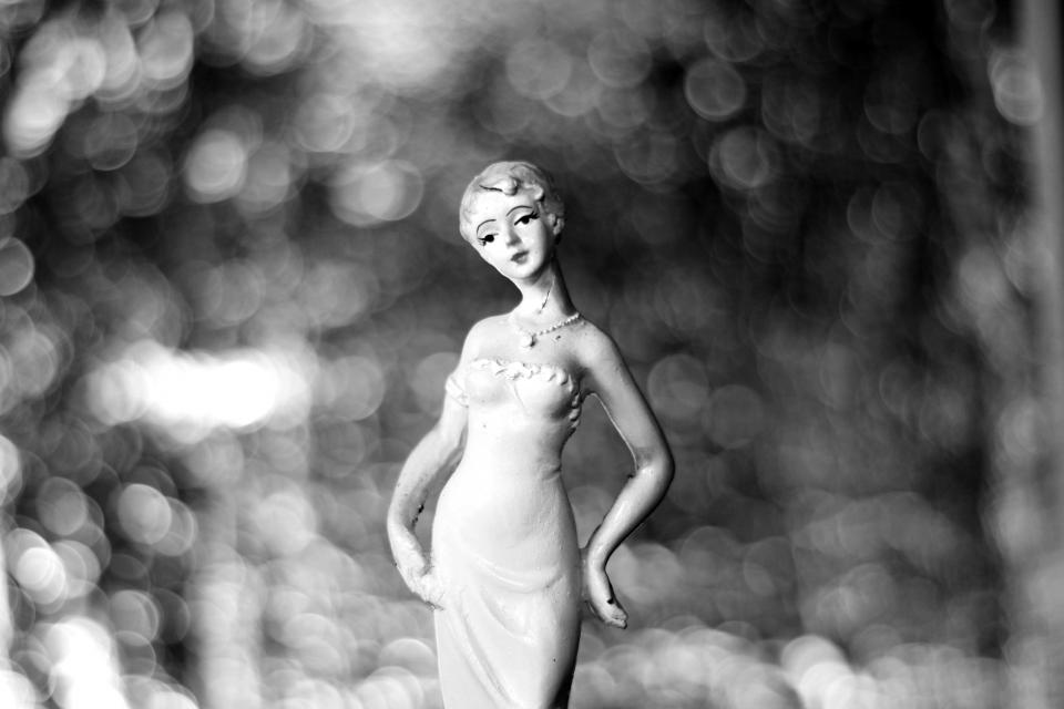black and white woman figurine bokeh
