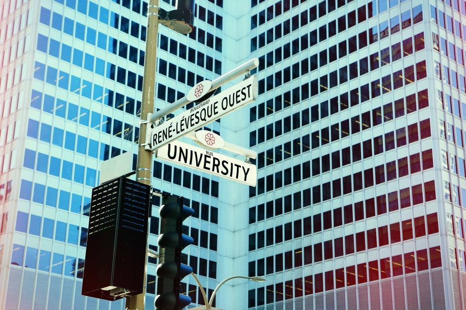 montreal downtown street corner traffic lights lamp posts sign buildings windows