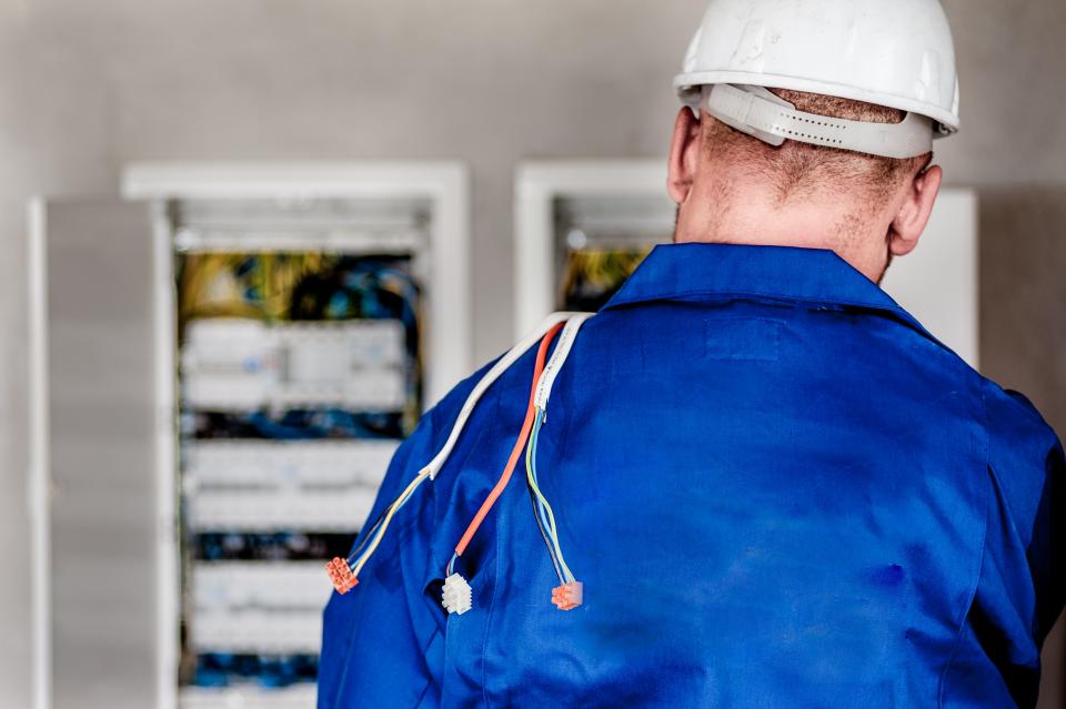 electrician electricity wires cables worker hard hat safety repairs construction building uniform