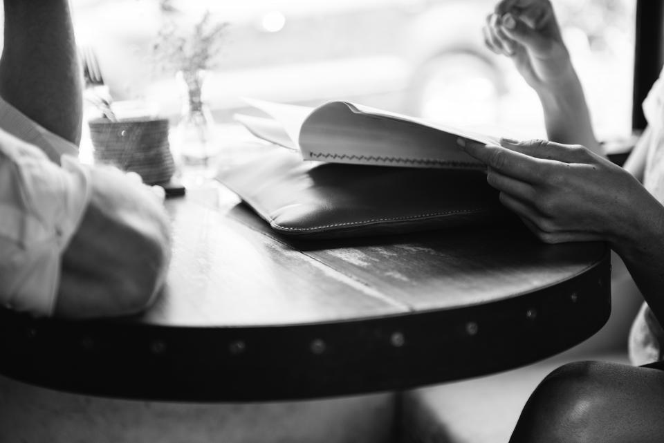 people restaurant table menu order black and white cafe