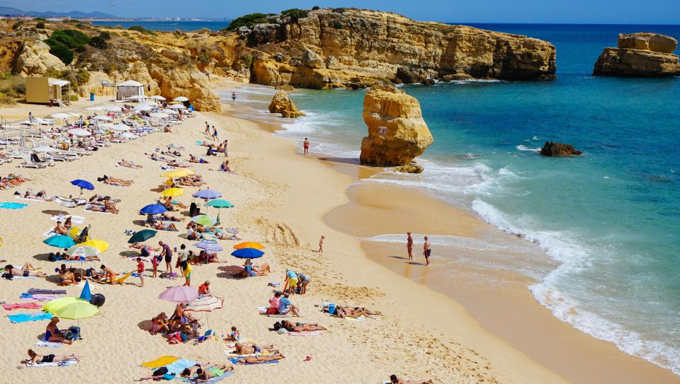 sea, ocean, water, waves, nature, white, sand, beach, coast, shore, people, men, women, crowd, umbrella, summer, vacation, swimming, rocks, cliff, hill