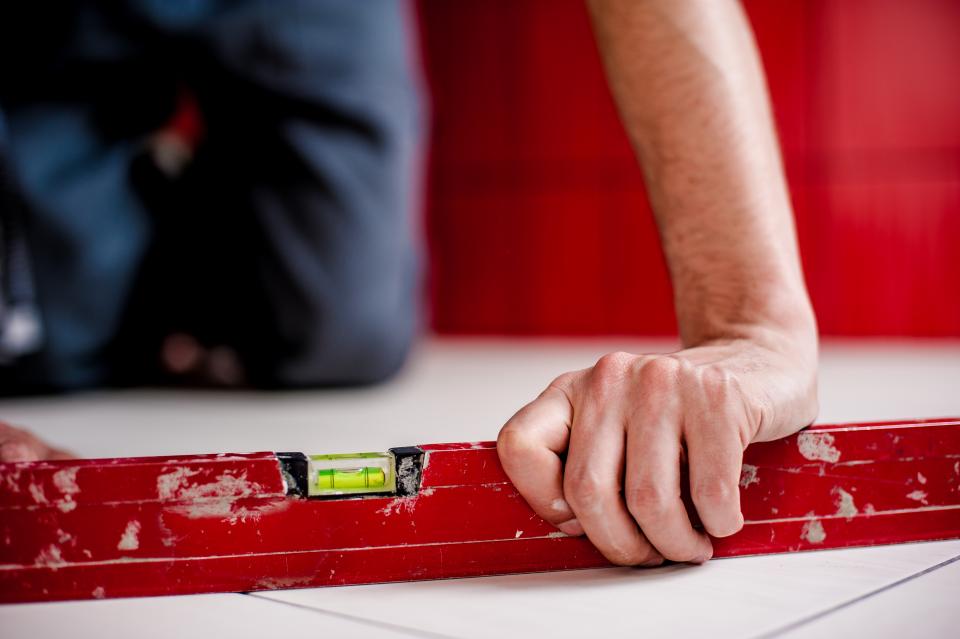 level construction repairs renovations safety architect worker hands floors house home