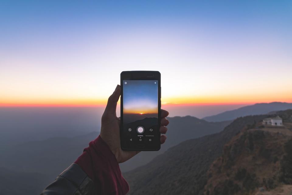 cellphone mobile touchscreen hand mountains view landscape house sky sunset capture nature photography picture