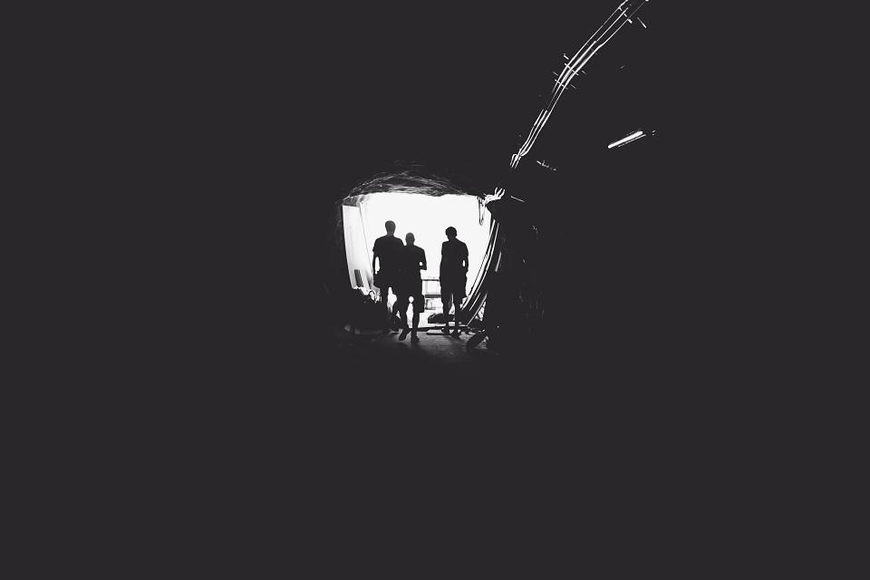 black and white people tunnel entrance open