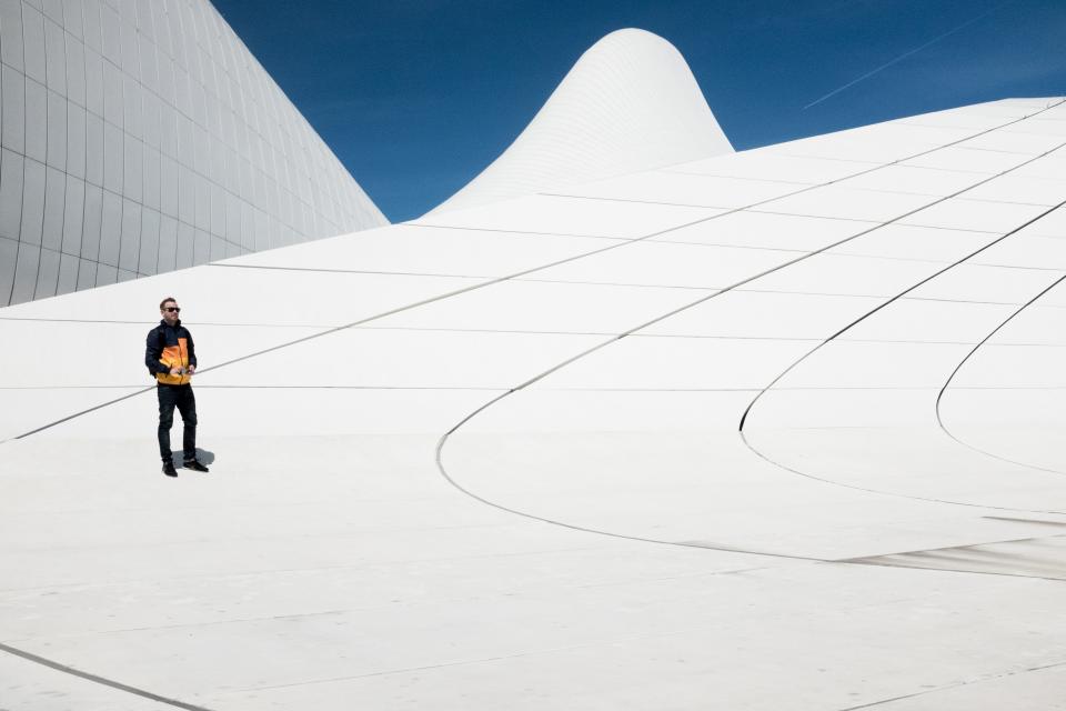 people man alone shadow shades sunglasses architecture roof top building establishment white