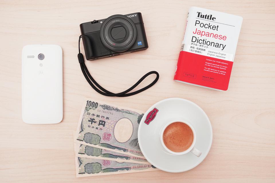 camera, sony, cellphone, technology, book, money, dictionary, yen, plate, tea, mug, cup, table, aesthetics, photography