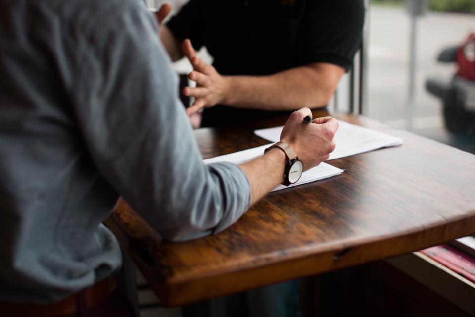 people, men, discuss, paper, pen, writing, wooden, table