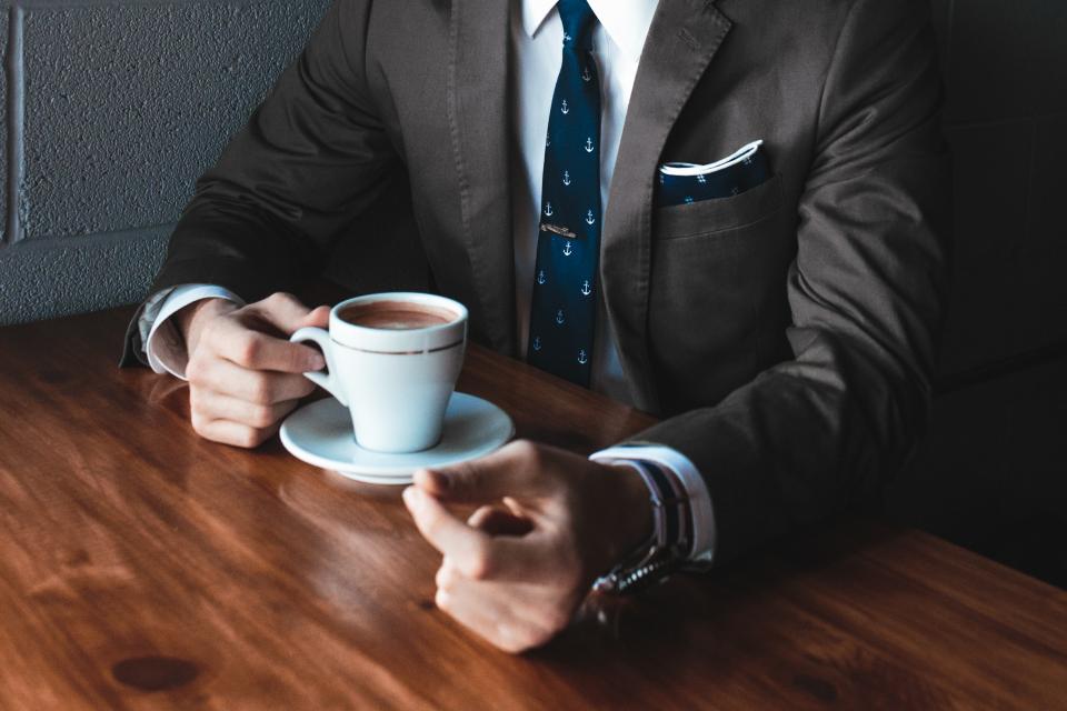 guy, man, male, people, bust, torso, suit, necktie, wrist, watch, professional, yuppie, office, business, work, meeting, break, coffee, cup, saucer, wooden, table