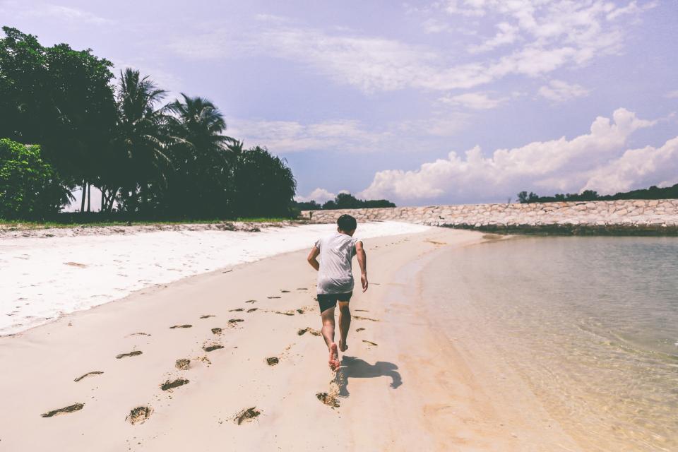 boy, guy, running, beach, sand, shore, footprints, fitness, exercise, shorts, tshirt, summer, sunny, palm trees, sky, people, health