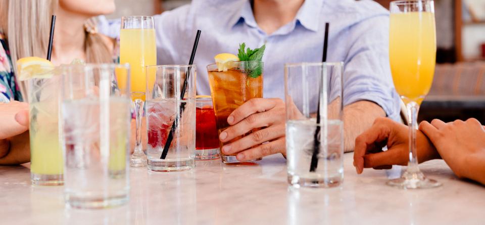 man woman people friends gathering event straws cocktail group glasses still bokeh 