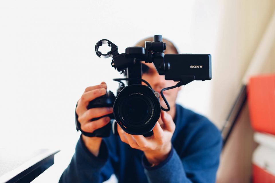 technology gadgets videography sony video recorder camcorder guy man male hold still bokeh