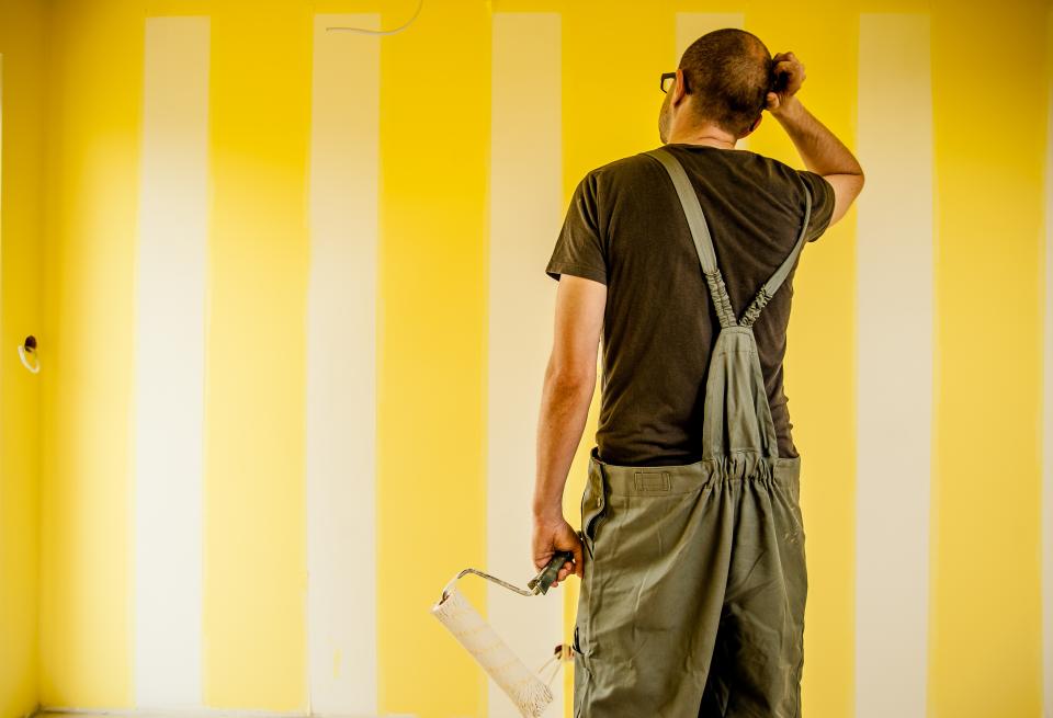 guy man painting brush roller overalls construction renovations repair house home walls people