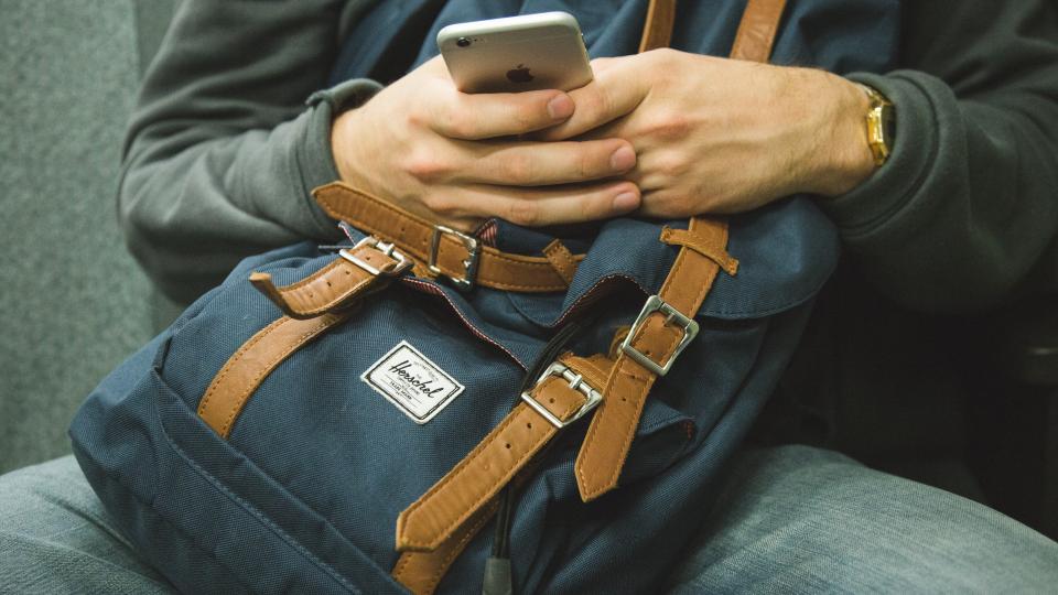 iphone texting mobile smartphone cell phone technology hands backpack knapsack people student