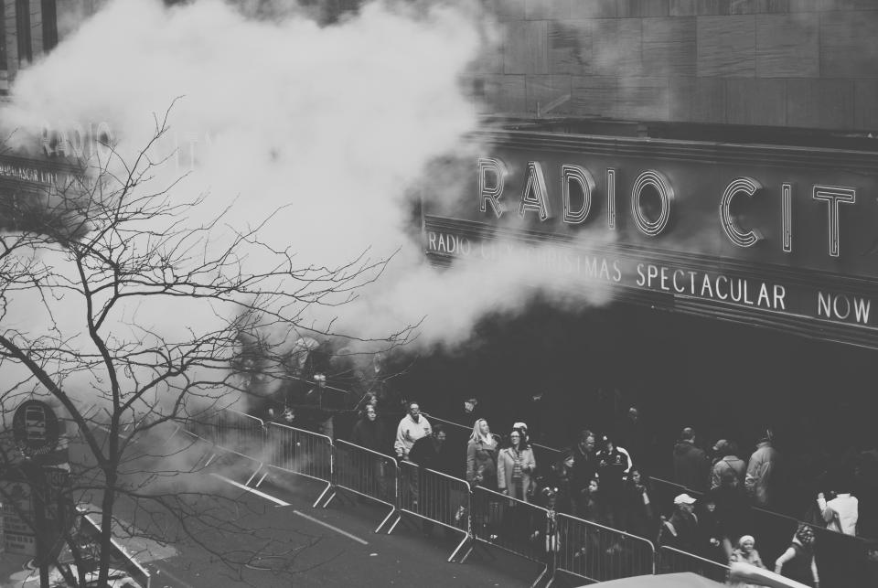 Radio City Music Hall music concert show people spectators city urban street black and white smoke fog