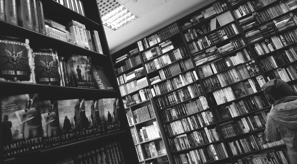 library books shelves racks black and white study knowledge research school literature tables chairs indoors people alone education