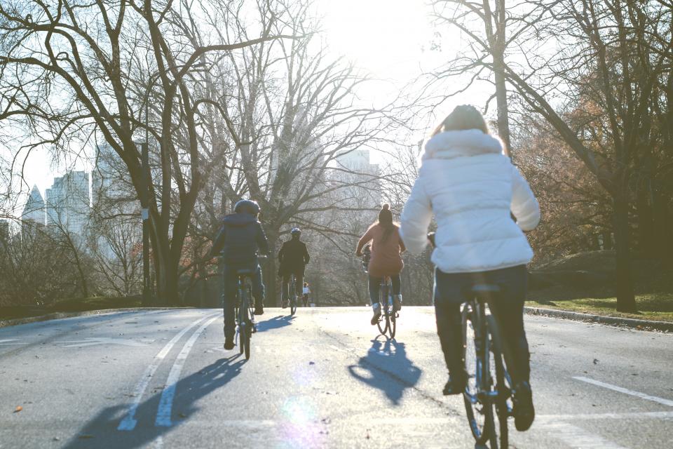 people, man, woman, kid, child, bike, bicycle, road, trees, road, street, hobby, establishment, urban, city, building, summer, flare