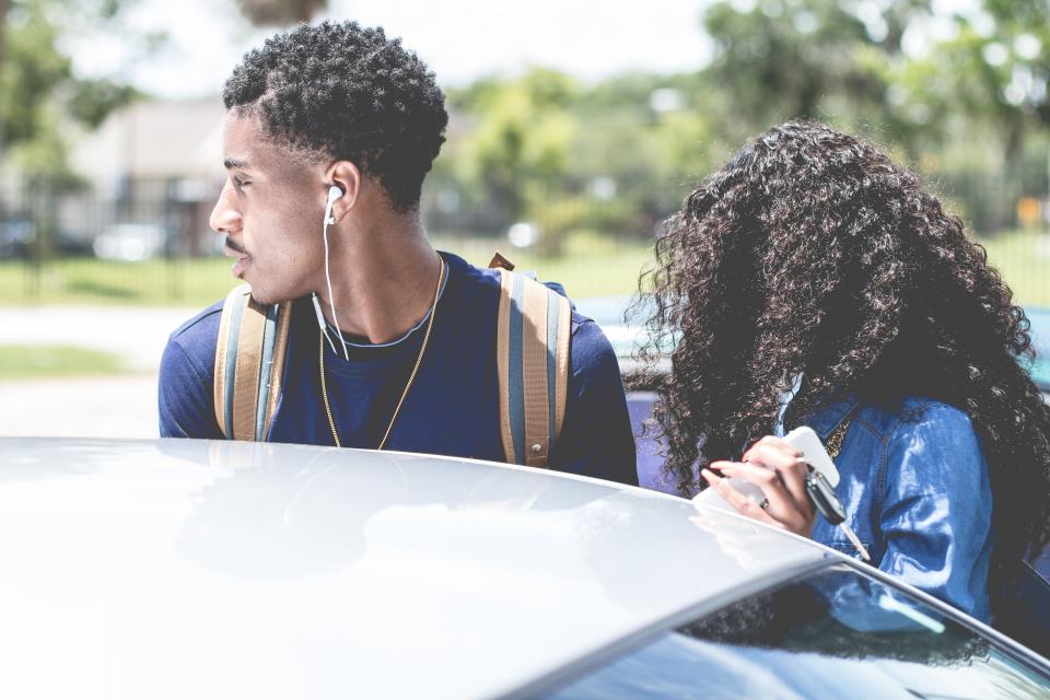 man woman girl guy curly car vehicle bokeh trees couple key earphone backpack street necklace windshield
