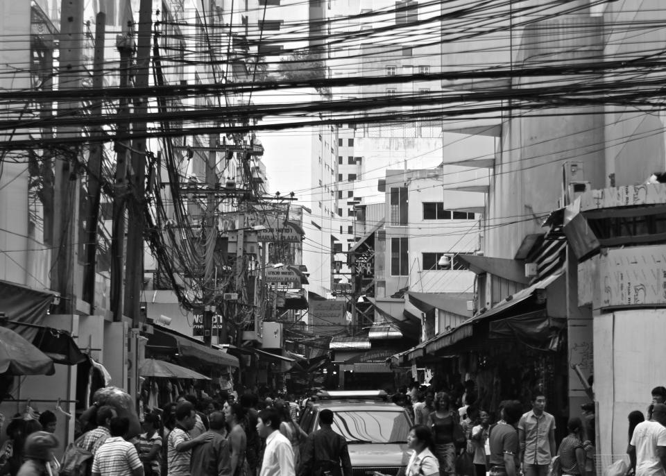people crowd busy streets city pedestrians buildings architecture black and white