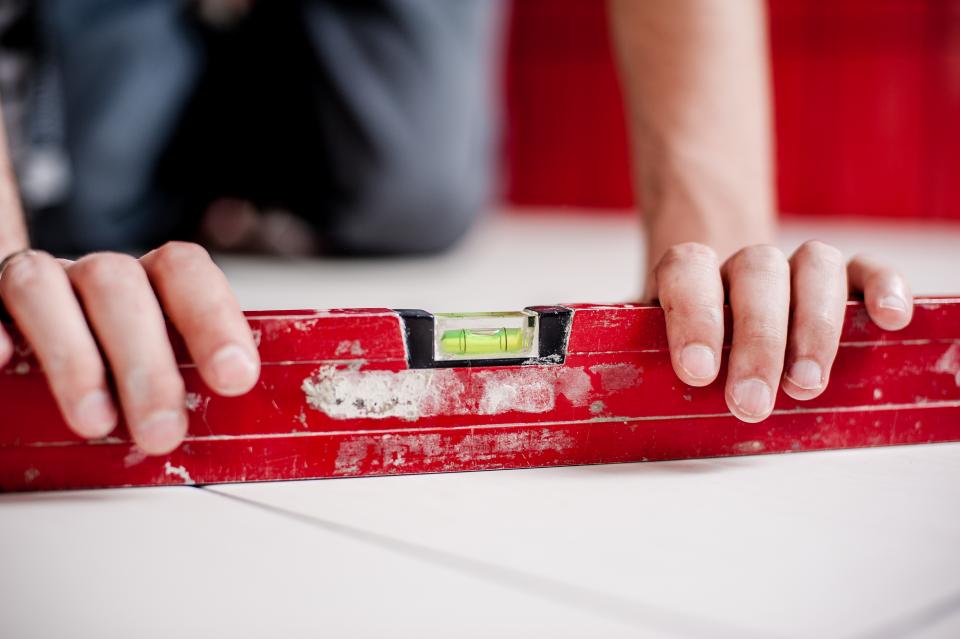 level construction repairs renovations safety architect worker hands floors house home