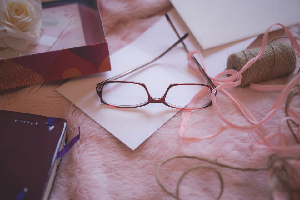 still items things reading glasses yarn box letter journal bokeh 