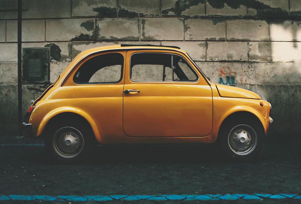 yellow car auto vehicle travel trip road street wall park 