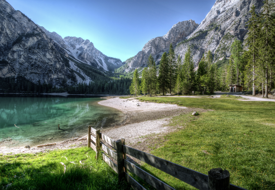 lake mountains lakeside dolomites summer sun water fence landscape blue sky green trees grass outdoors hd wallpaper desktop wallpaper