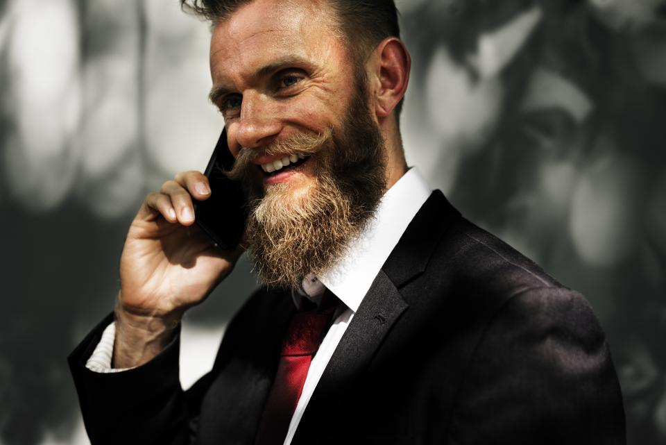 guy, man, people, smile, smiling, happy, mobile, cell phone, talking, business, suit, tie, moustache, beard