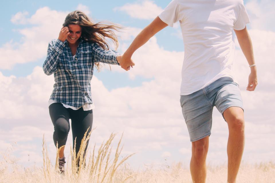 sky, clouds, grass, outdoor, people, couple, love, smile, happy, man, guy, girl, woman, dating, holding hands